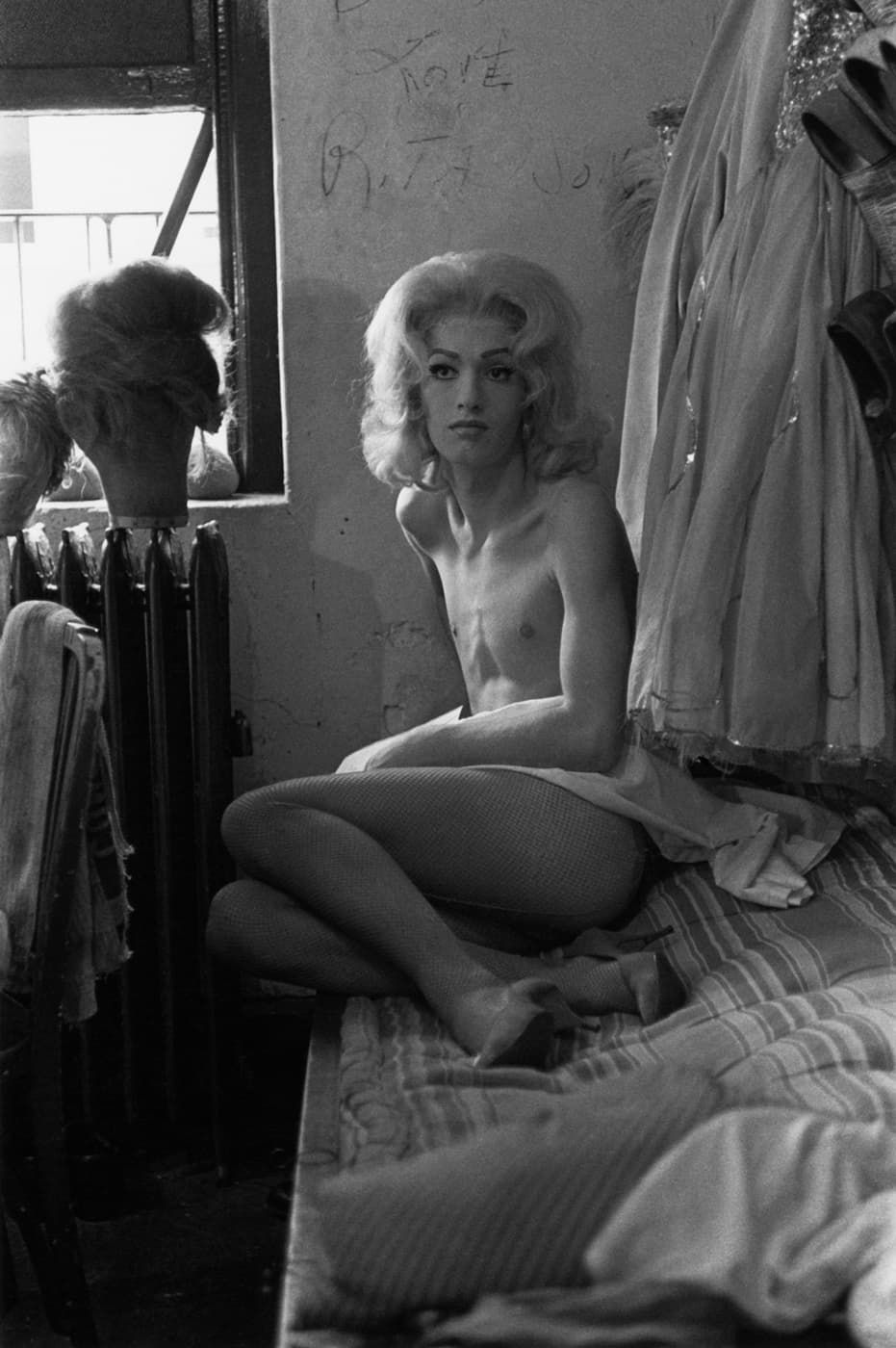 Diane Arbus, Female impersonator on bed, N.Y.C., 1961. Gelatin silver print by Neil Selkirk, 16 × 12 ¾ inches (framed). Courtesy Fraenkel Gallery.