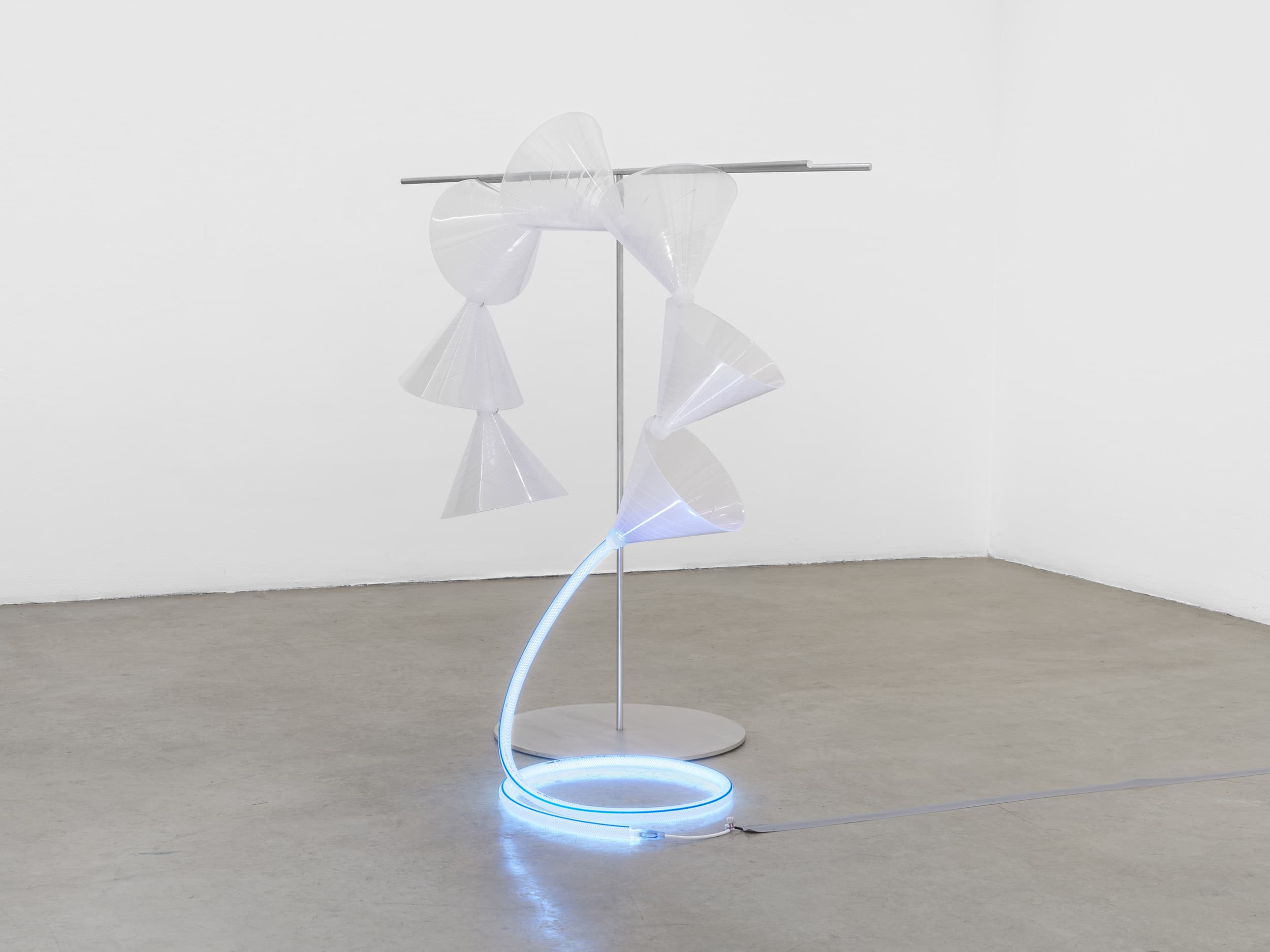 Yuko Mohri, Moré Moré (Leaky): Sieves, 2024. Iron, hose, funnel, LED light, 56 ½ × 59 × 35 inches. Courtesy the artist and Tanya Bonakdar Gallery.