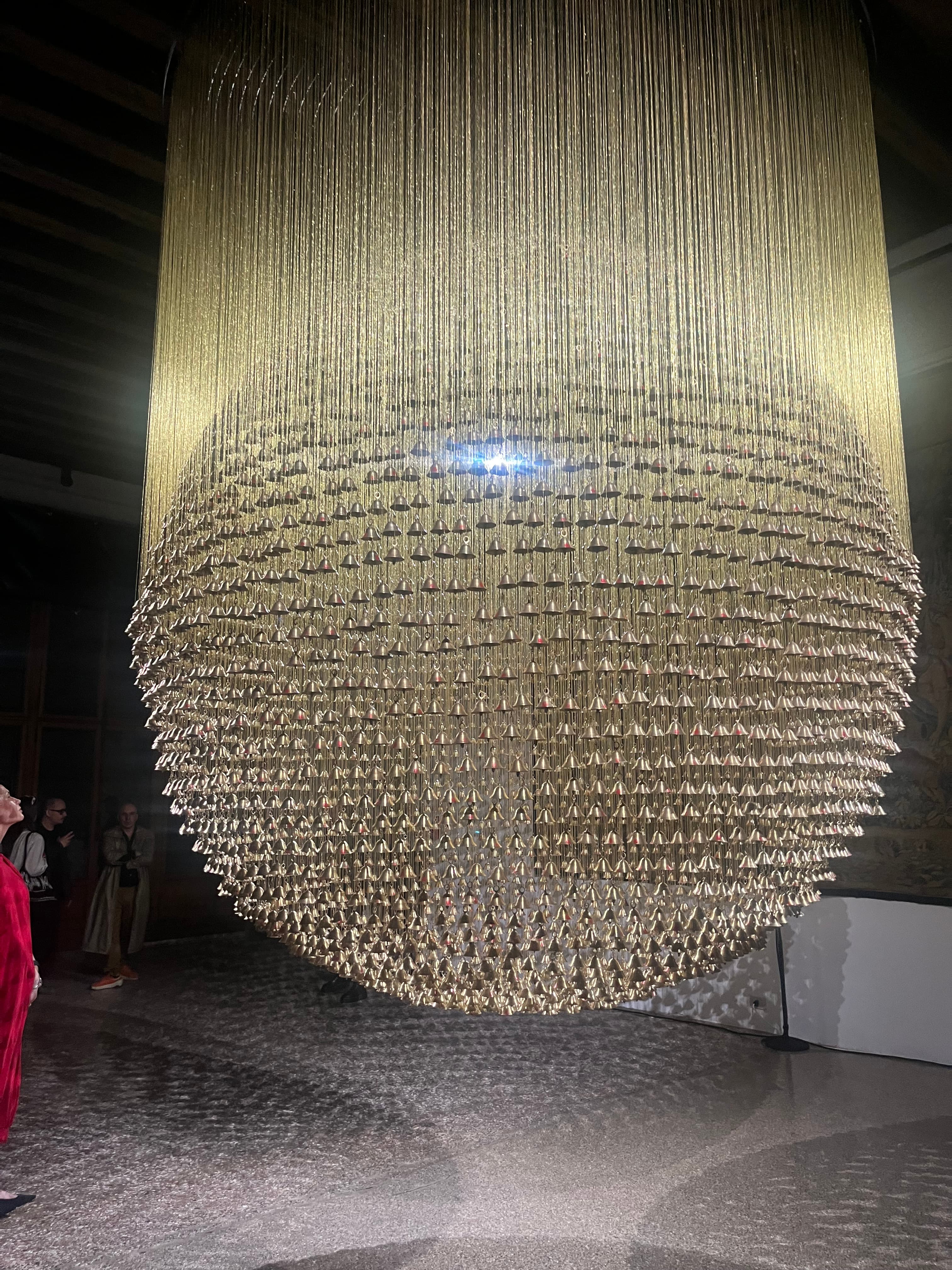 Ashfika Rahman, Than Para — No Land Without Us, 2025– . Installation with 4,849 temple bells (brass) bearing collected thumbprints from the community, golden silk threads, and metal frame. Courtesy the artist, in collaboration with the community of Than Para and the Chittagong Hill Tracts, Bangladesh. Photo: Monika Fabjinska.